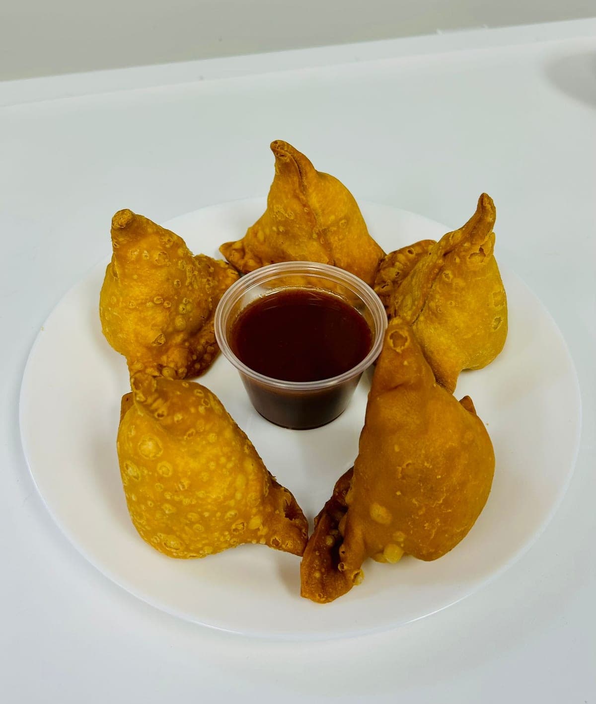 Crispy golden samosas with chutney